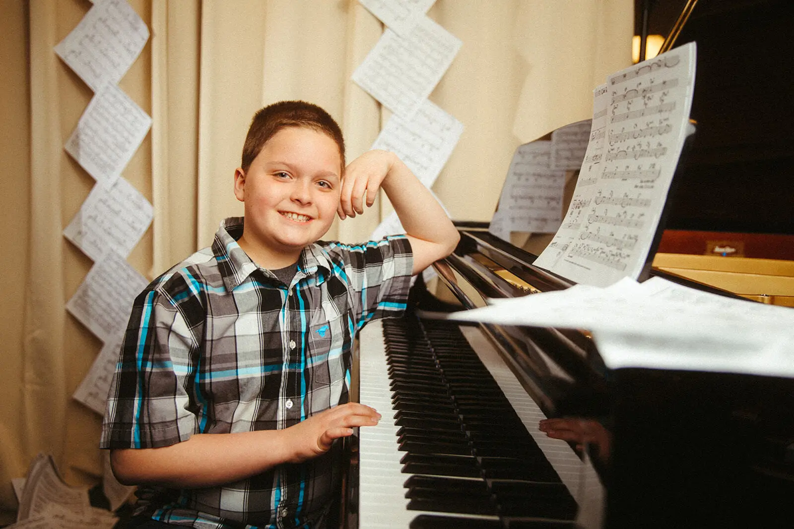 A Boy Sitting in Front of a Piano